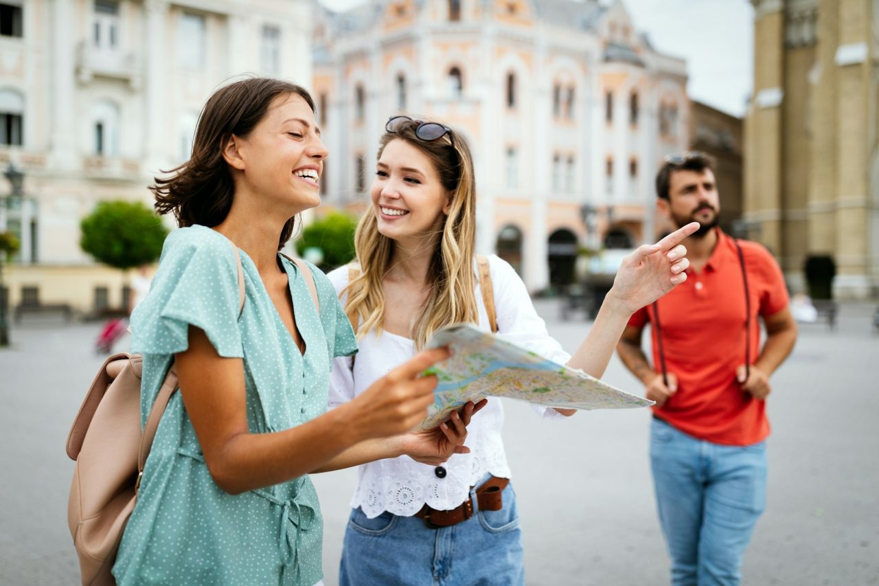 General Insurance Products 12 happy traveling tourists sightseeing with map in hand